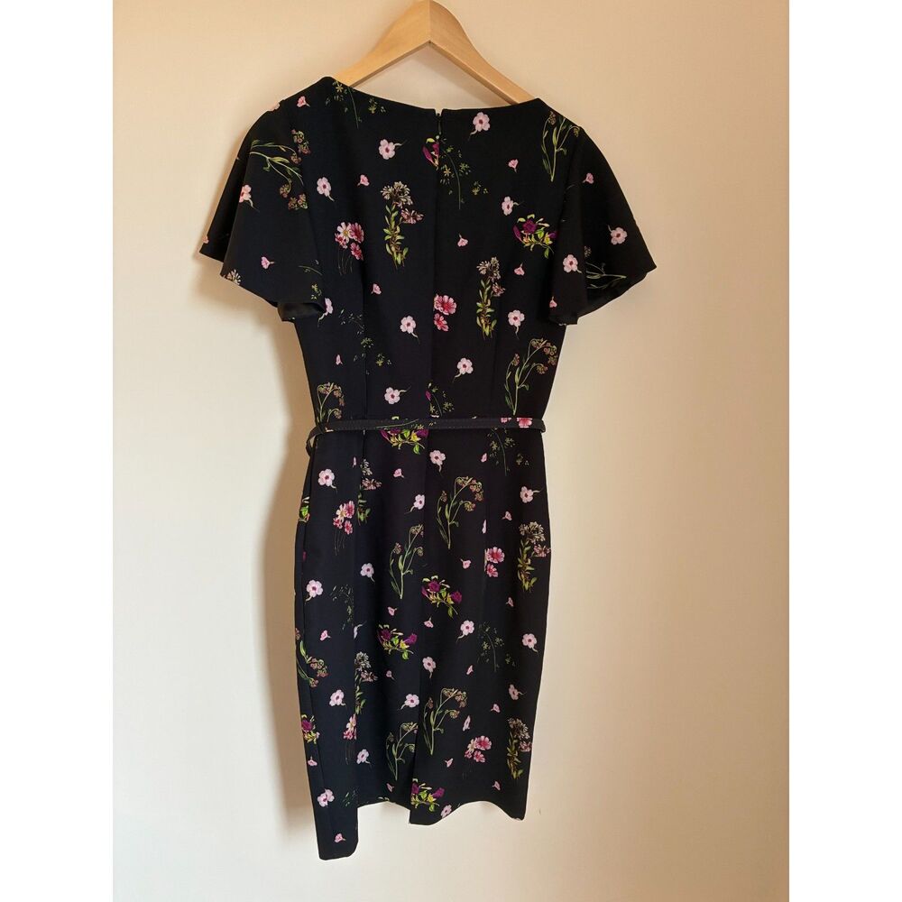 David Meister sheath dress features a black floral print and a belted waist